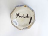 a small bowl with a writing on it on a table