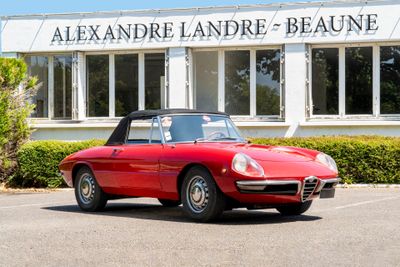 a red sports car parked in front of a building