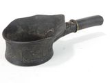 a black mortar with a wooden handle on a white surface