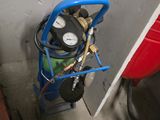 a blue cart with a pressurer and a gauge on it