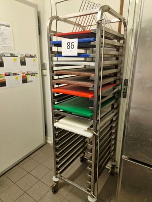 many trays of food on a metal rack in the kitchen