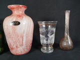 three vases and a glass on a black background