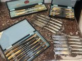 many different types of knives in a case on a table