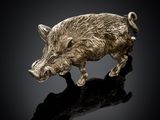 a close up of a boar figurine on a black surface