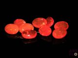 some red lights are lit up in the dark on a black surface