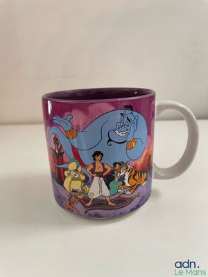 a close up of a coffee cup with a cartoon character on it