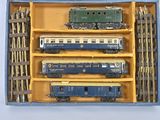 a box with a bunch of toy trains inside of it