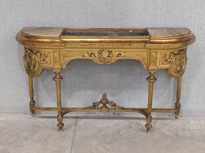 a gold table with a marble top on it