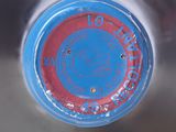 a close up of a bottle of water with a blue lid