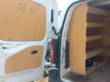 a white van that has some shelves in the back of it