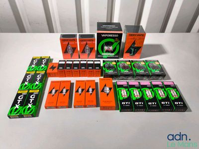 many different boxes of cigarettes on a white table