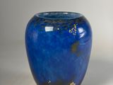 a blue vase that is sitting on a table