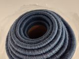 a coil of yarn wrapped in plastic on a table