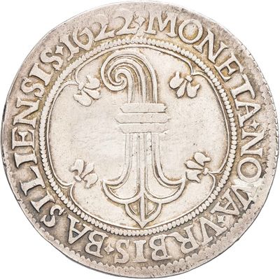 a silver coin with an anchor and a cross on it