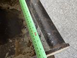 a measuring tape on the side of a piece of metal