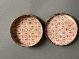 pair of small pink and green plates with floral designs on them