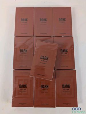 a group of six boxes of dark chocolate sitting on top of each other