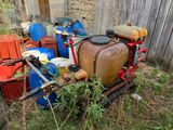 a lot of trash in the yard next to a fence
