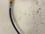 a yellow and black hose attached to a white wall