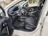 the interior of a car with the door open and the driver ' s seat down