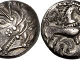a silver coin with an image of a dragon on it