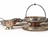 a silver plate with a silver gravy and a silver saucer