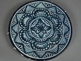 a blue and white plate with a circular design on it