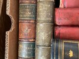 many old books in a box on the shelf