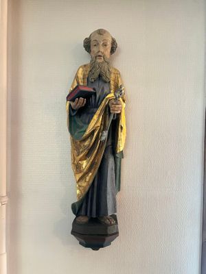 a statue of a man holding a book in his hand