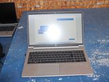 a laptop computer sitting on a table with a bag