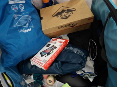 a blue bag full of stuff sitting in the back of a car