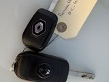 two car keys and a sticker on a table