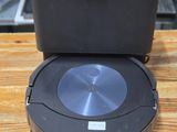 an image of a robotic vacuum cleaner sitting on top of a wooden table