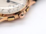 a close up of a watch on a white surface