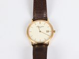 an image of a close up of a wrist watch on a white surface