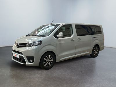 the silver van is parked in a large white room