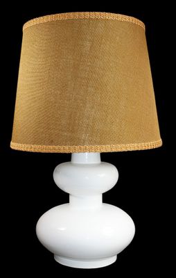 a white table lamp with a brown shade on it