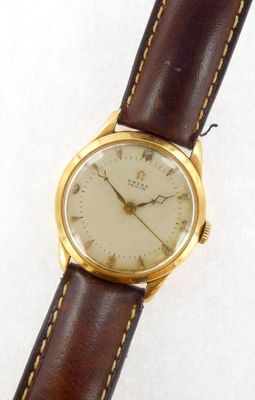 an image of a close up of a wrist watch on a white surface
