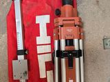 an image of a tripod and a tool bag on the ground