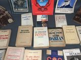 several books on a table with pictures and pictures of people on them