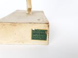 a gold statue of an apple tree on top of a box