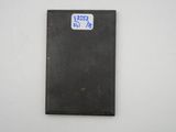 a black piece of metal with a blue sticker on it