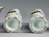 two vases are sitting side by side on a gray surface