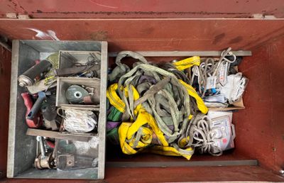 a wooden box filled with assorted items and tools