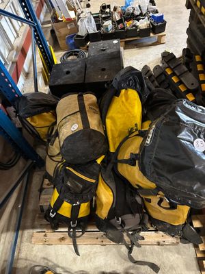 a pile of luggage sitting on top of a pallet in a warehouse