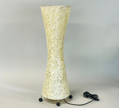 a tall yellow vase with a black cord on it