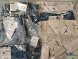 several pairs of men ' s jeans are wrapped in plastic bags