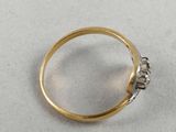 a close up of a gold ring with diamonds on a white surface
