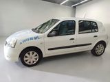 a small white car that is parked in a garage