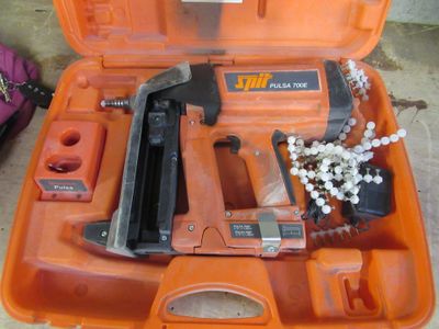une boîte à outils contenant une agrafeuse, une agrafeuse et d'autres objets